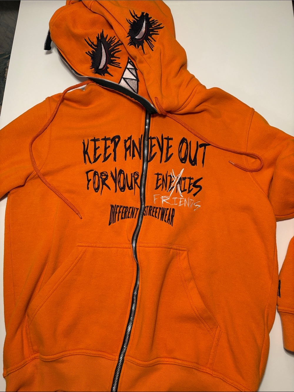 Orange Graphic Zip-Up Hoodie with Eye Motif